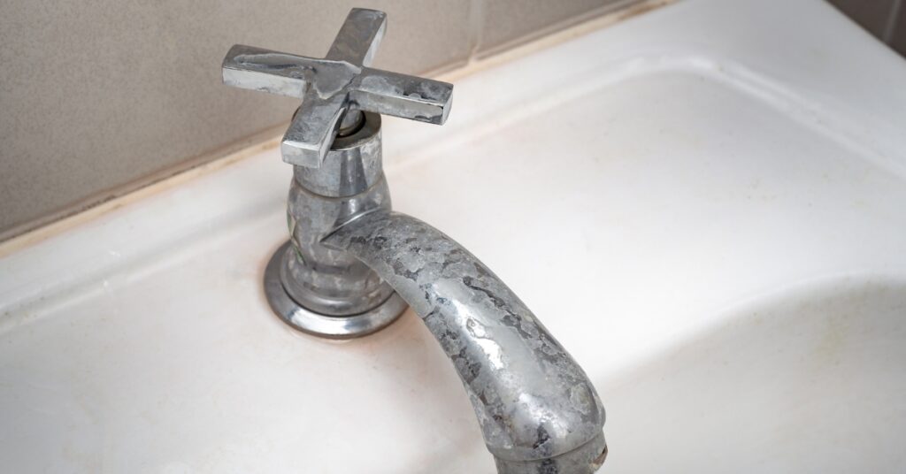 Dirty faucet with stain and limescale