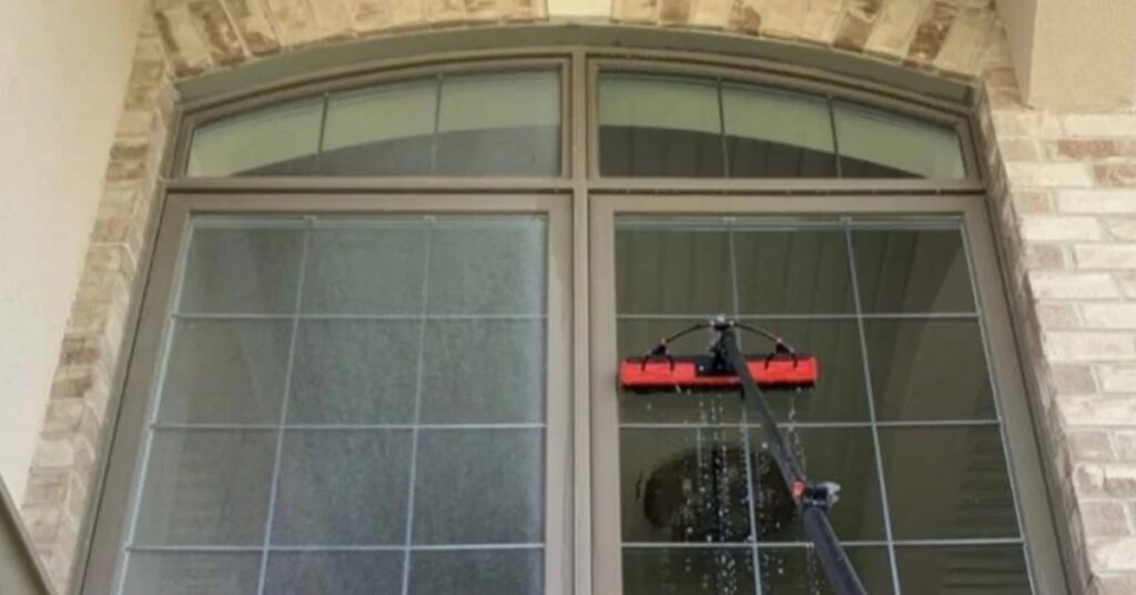 A before and after shot of a window getting cleaned